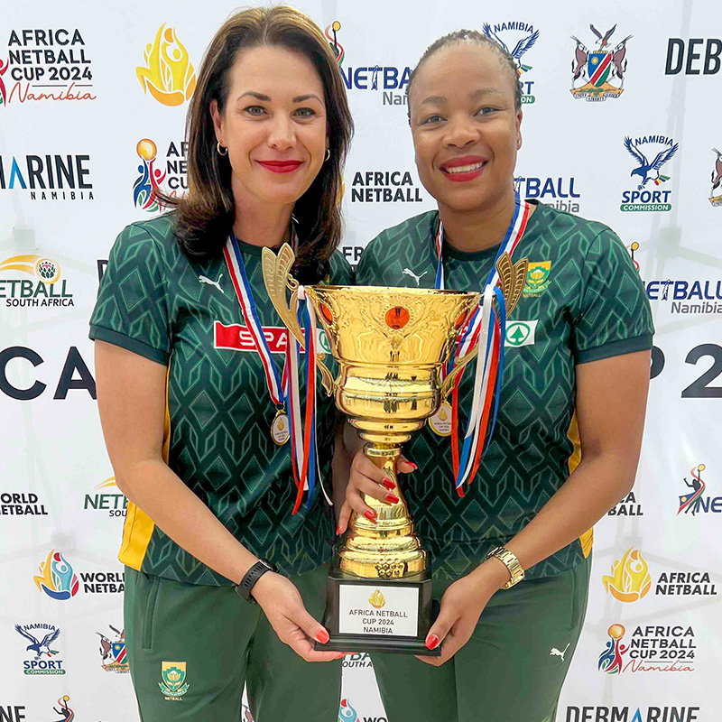 Africa netball champion coaches, Spar Proteas Head Coach Jenny van Dyk and Assistant Coach Zanele Mdodana smile with the continental trophy.