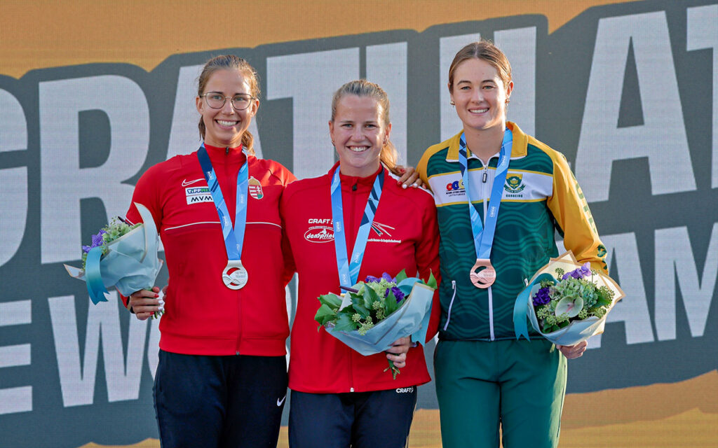 Hungarian Panna Csepe (silver), Dane Pernille Hostrup (gold) and South African Jade Wilson (bronze) for the U23 women's podium at the ICF Canoe Marathon World Championships in Gyor, Hungary, on Friday, 5 September, 2025. Photo: ICF / Gameplan Media