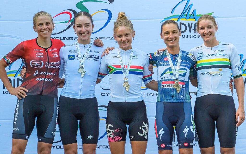 The top five women’s individual Road Race finishers (from left) S’annara Grove (5th place), Lisa Bone (Silver), Tyler Jacobs (Gold), Ashleigh Moolman Pasio (Bronze), and Anya du Plessis (4th place) on the podium following the 2026 Elite Women’s Individual Road Race at Rosenbush Estate in Walkerville, Midvaal, on Saturday, 8 February. All Photos: Cycling South Africa