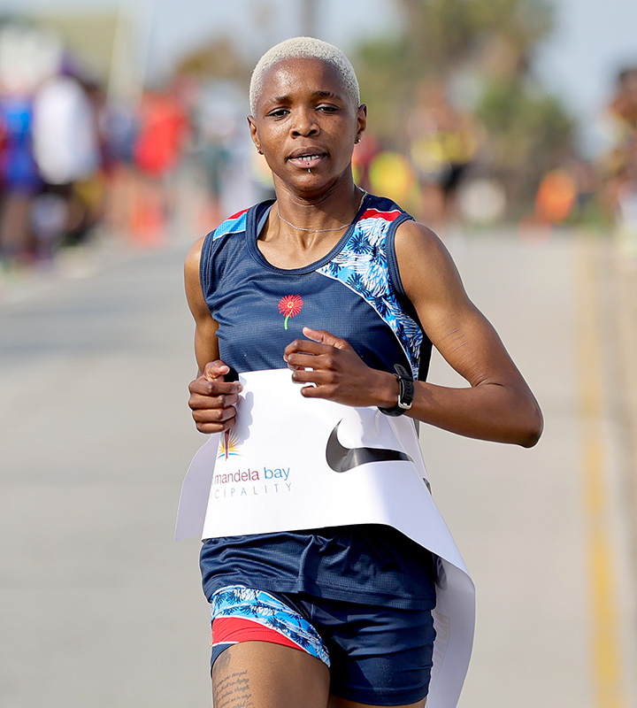 Karabo More on her way to winning the women's mile title at the ASA Road Running Championships at Pollok Beach in Gqeberha.