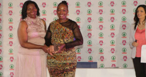 Ravele is bestowed with the 2012 Hall of Fame trophy by Eastern Cape women's rugby pioneer and 2011 Hall of Famer, Dorothy Tsotsobe, as Awards MC Leanne Manas looks on. Photo: Reg Caldecott / gsport4girls